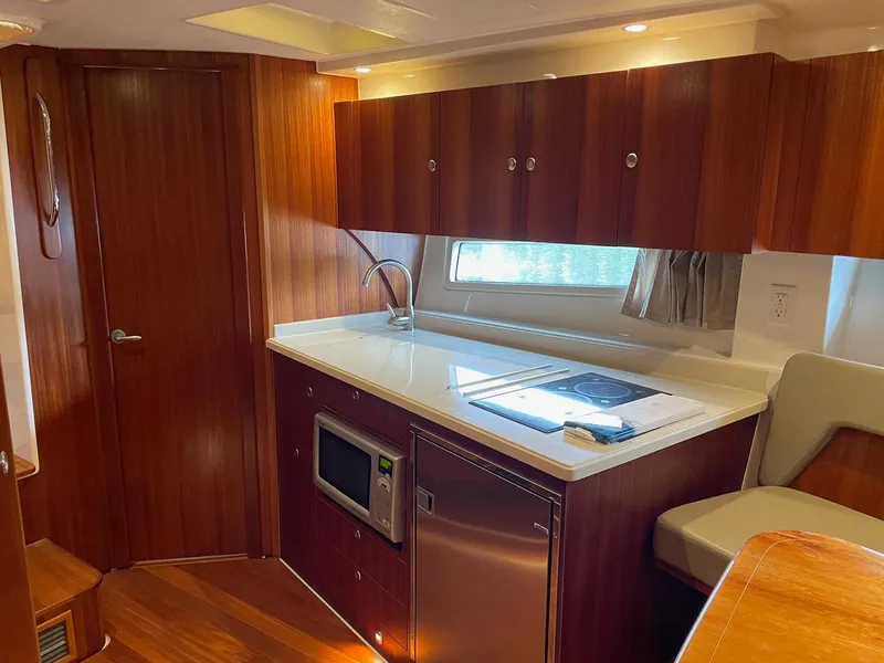 Slide: The Image of 2014 Pursuit SC 365i Sport Coupe interior with modern kitchen and wood cabinetry. - 21
