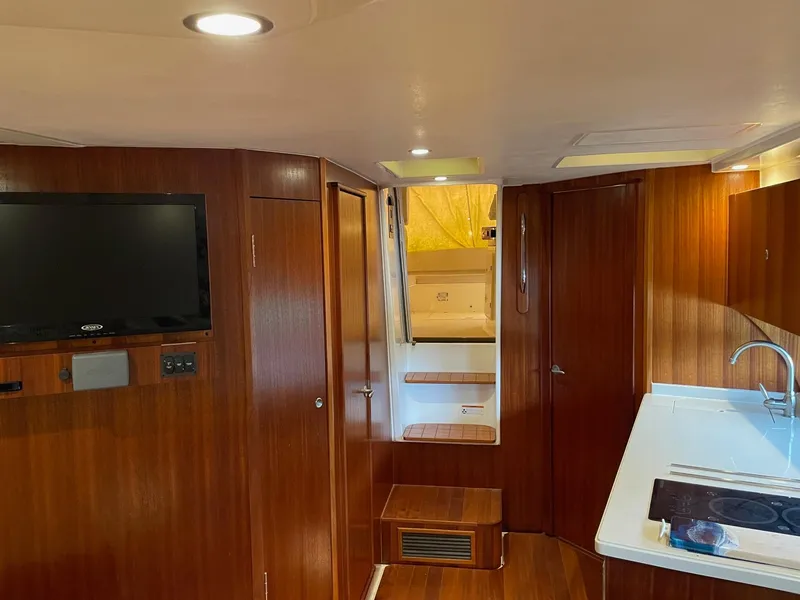 Slide: The Image of Interior of 2014 Pursuit SC 365i Sport Coupe with wood paneling and modern amenities. - 22