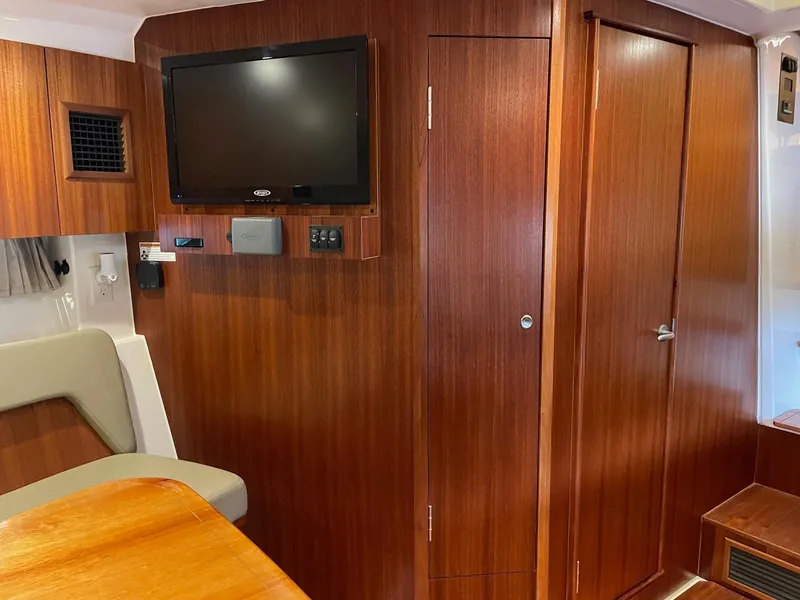 Slide: The Image of Interior of 2014 Pursuit SC 365i Sport Coupe with wood paneling and mounted TV. - 23