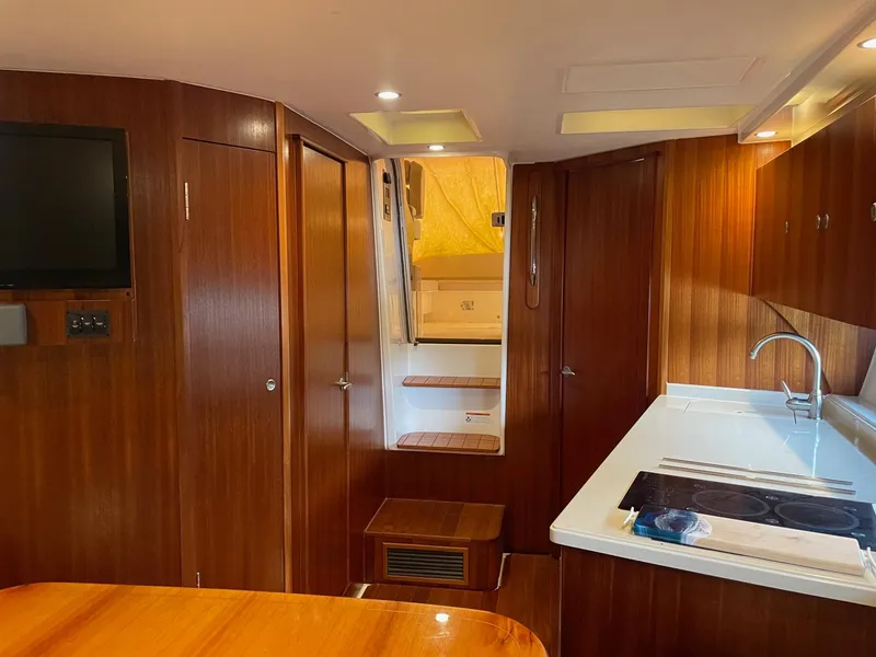 Slide: The Image of Interior of 2014 Pursuit SC 365i Sport Coupe with wood finish and modern amenities. - 24