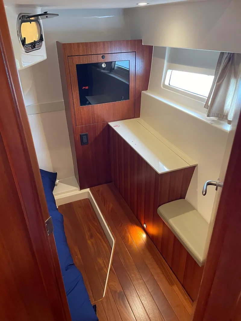 Slide: The Image of 2014 Pursuit SC 365i Sport Coupe interior with wood finish and modern amenities. - 25