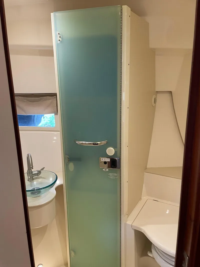 Slide: The Image of 2014 Pursuit SC 365i Sport Coupe bathroom with frosted glass shower door and modern fixtures. - 26