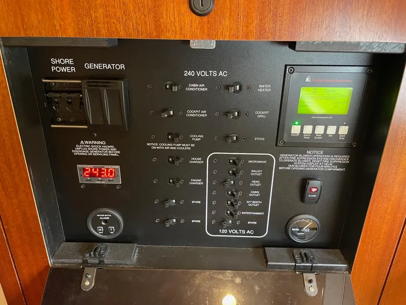 Slide: The Image of Control panel of a 2014 Pursuit SC 365i Sport Coupe, featuring shore power and generator switches. - 30