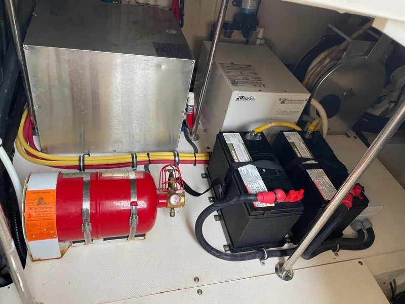 Slide: The Image of 2014 Pursuit SC 365i Sport Coupe engine room with batteries and fire extinguisher. - 31