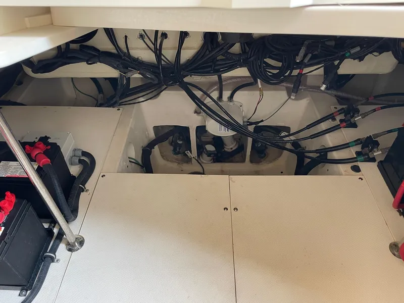 Slide: The Image of 2014 Pursuit SC 365i Sport Coupe engine compartment with wiring and battery setup. - 34