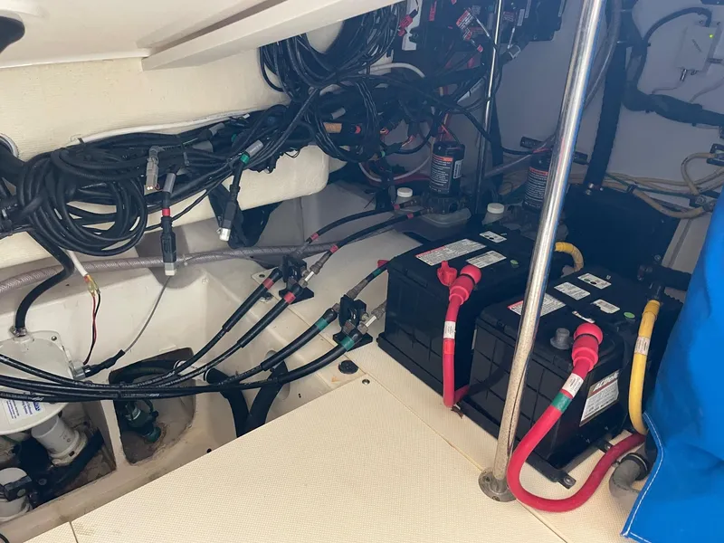 Slide: The Image of 2014 Pursuit SC 365i Sport Coupe engine room with batteries and wiring. - 36