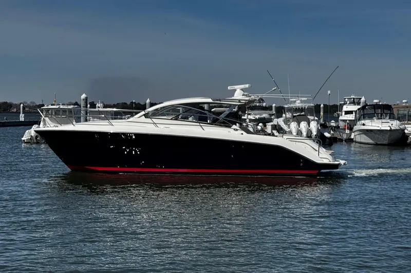 Slide: The Image of 2014 Pursuit SC 365i Sport Coupe yacht docked in marina under clear sky. - 7