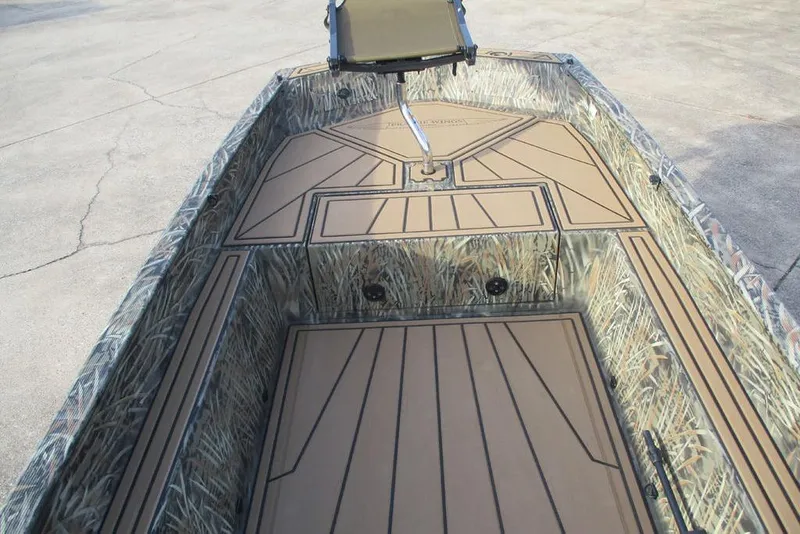Slide: The Image of 2026 Tracker Grizzly 1650 T Prairie Wings Edition boat interior with camouflage design. - 3
