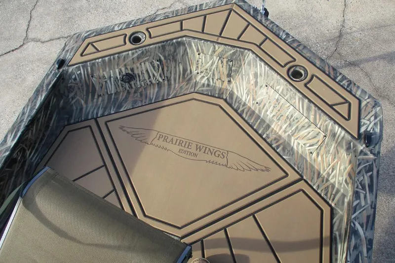 Slide: The Image of 2026 Tracker Grizzly 1650 T Prairie Wings Edition boat interior with camouflage design. - 8