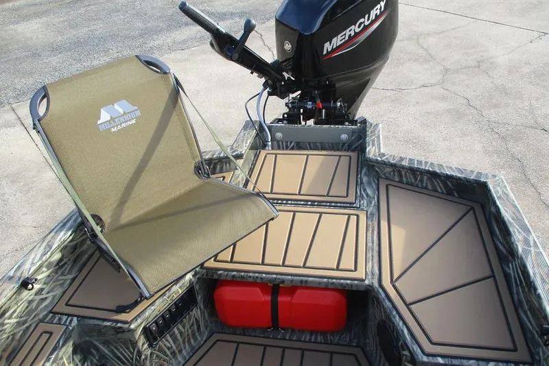 Slide: The Image of 2026 Tracker Grizzly 1650 T Prairie Wings Edition boat interior with Mercury motor and marine chair. - 9