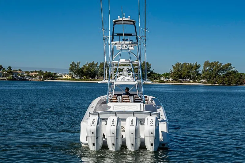 Slide: The Image of Sparks 46 boat, 2025 model, cruising on a serene lake with clear blue skies. - 101