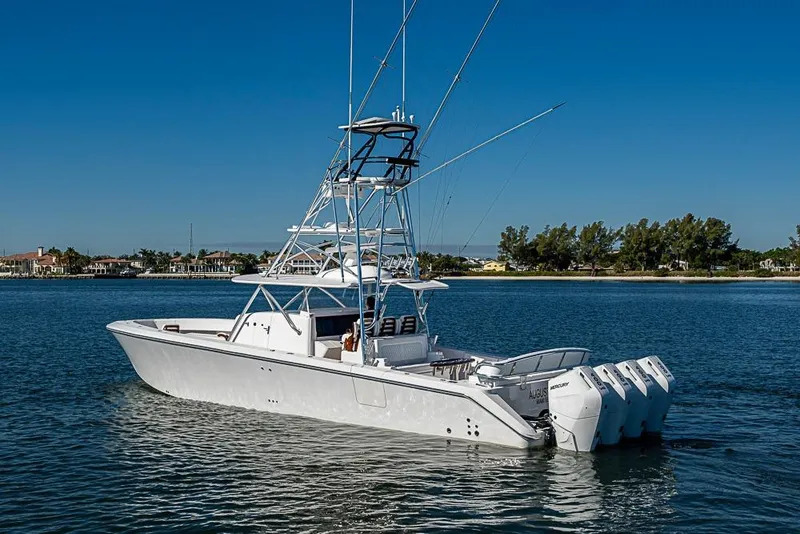 Slide: The Image of 2025 Sparks 46 boat with multiple engines on calm water, clear blue sky. - 103