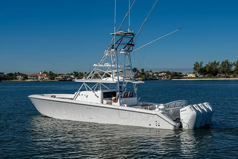 Slide: The Image of A 2025 Sparks 46 boat with multiple outboard engines on a calm waterway. - 104