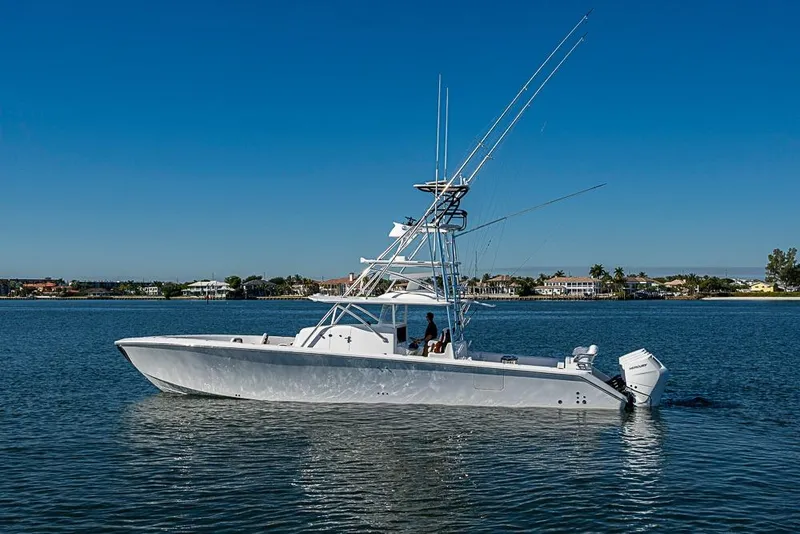 Slide: The Image of 2025 Sparks 46 boat on calm water under clear blue sky. - 107