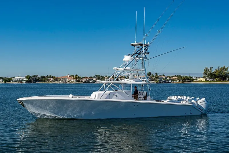 Slide: The Image of 2025 Sparks 46 yacht cruising on a sunny day near coastal homes. - 108