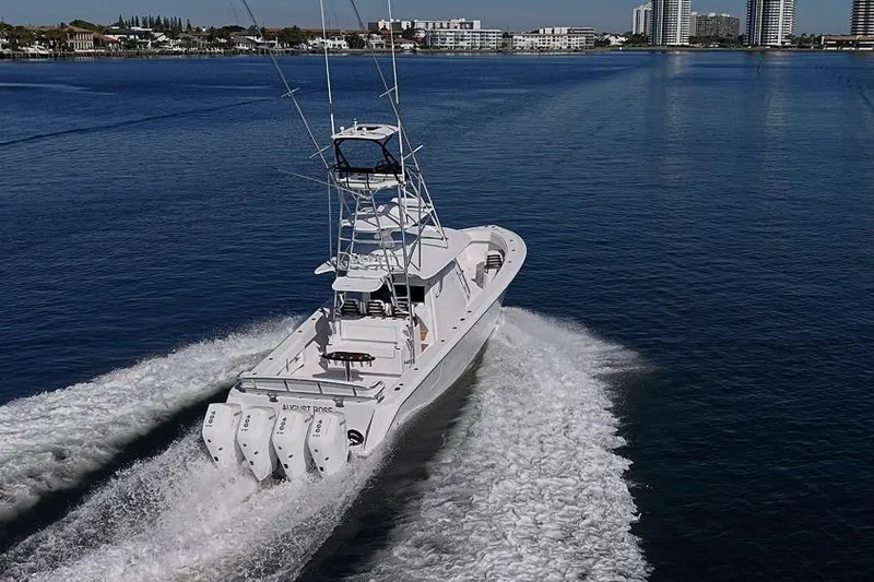 Slide: The Image of A 2025 Sparks 46 boat cruising on a calm blue waterway. - 11