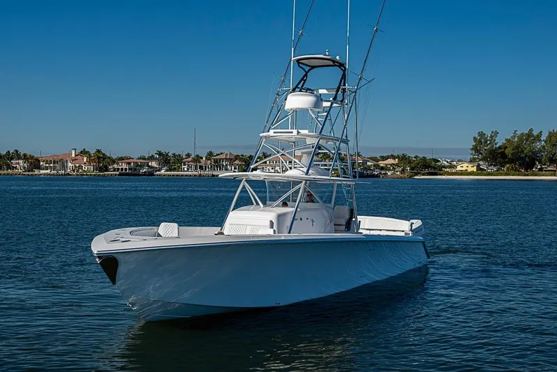 Slide: The Image of Sparks 46 boat, 2025 model, cruising on a calm blue waterway. - 111