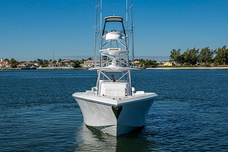 Slide: The Image of 2025 Sparks 46 boat on calm water with clear blue sky background. - 112