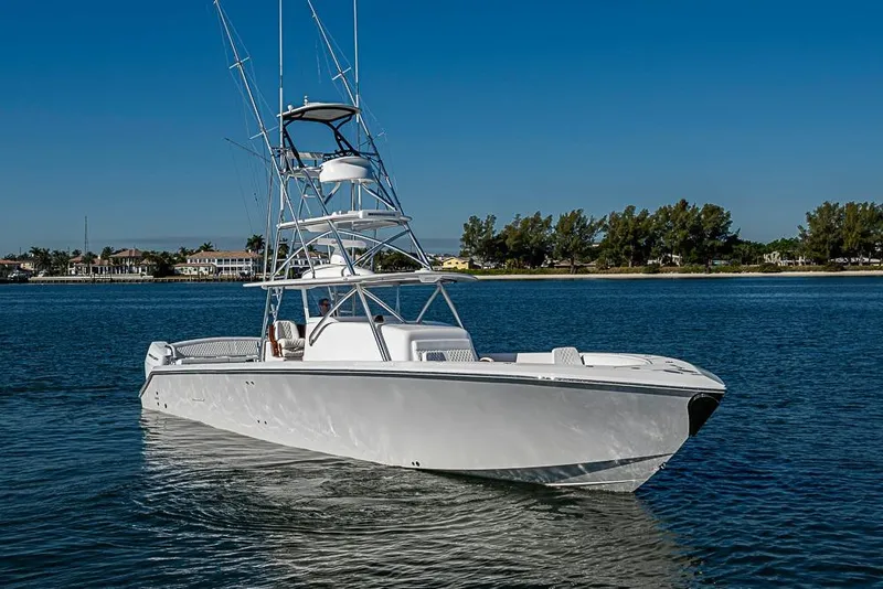 Slide: The Image of A sleek 2025 Sparks 46 boat cruising on calm waters under a clear blue sky. - 113