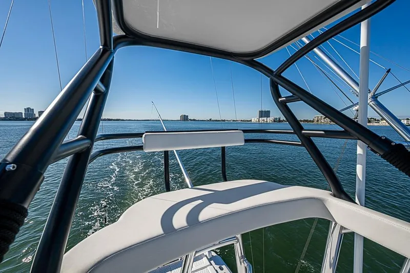 Slide: The Image of View from Sparks 46 boat, 2025 model, overlooking calm waters and city skyline. - 117