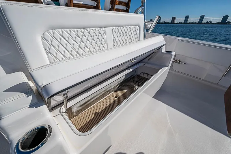 Slide: The Image of Luxury seating on Sparks 46 yacht, 2025 model, with storage compartment open, ocean view. - 121