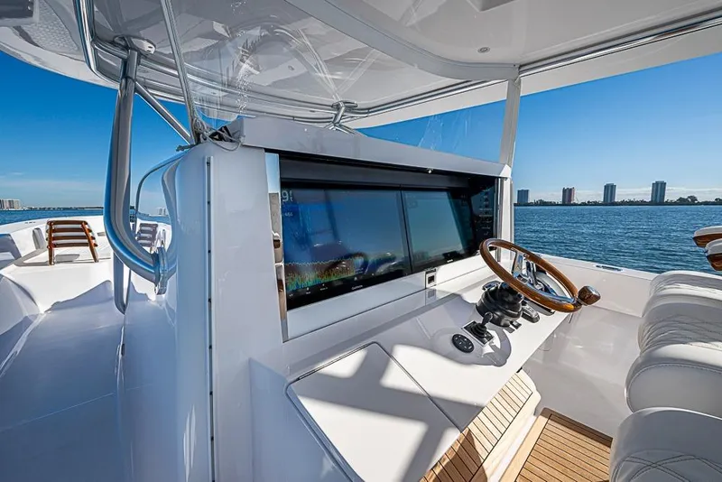 Slide: The Image of Modern Sparks 46 yacht cockpit with advanced navigation system, overlooking serene ocean view, 2025 model. - 122