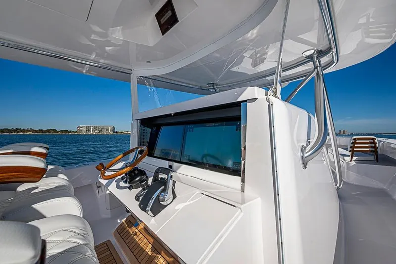 Slide: The Image of Luxury Sparks 46 yacht helm with modern controls, overlooking serene ocean view, 2025 model. - 123
