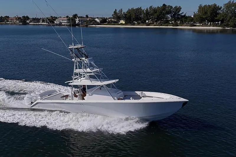 Slide: The Image of A 2025 Sparks 46 yacht cruising on a calm, scenic waterway. - 13