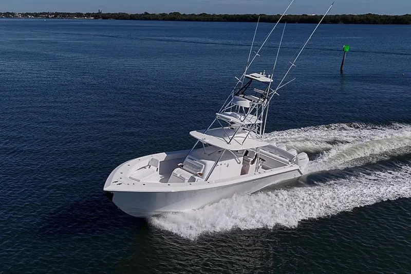 Slide: The Image of Sparks 46 boat cruising on open water, 2025 model, with clear blue sky. - 21