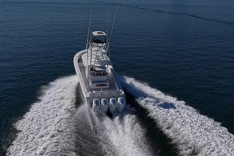 Slide: The Image of A 2025 Sparks 46 boat cruising on open water, leaving a wake behind. - 34