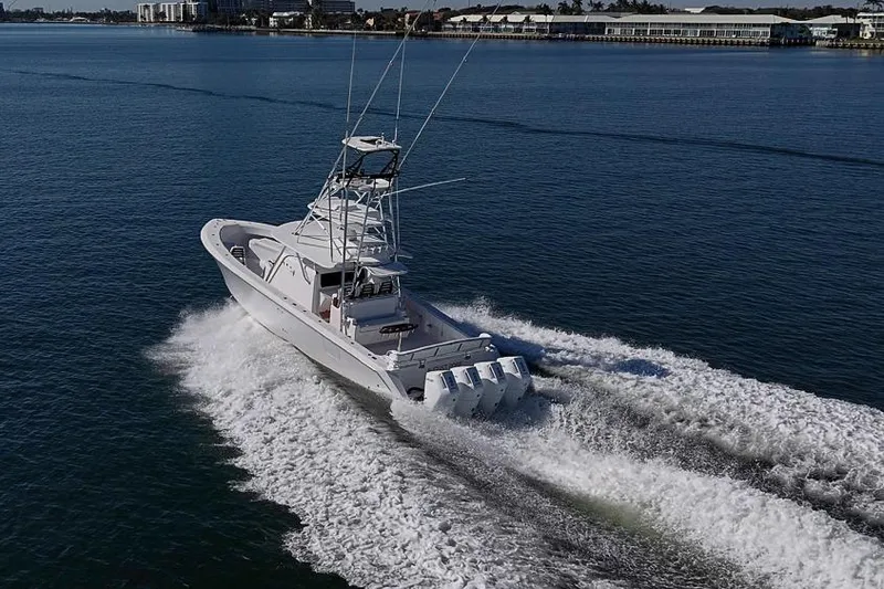 Slide: The Image of A 2025 Sparks 46 boat cruising swiftly on open water. - 35