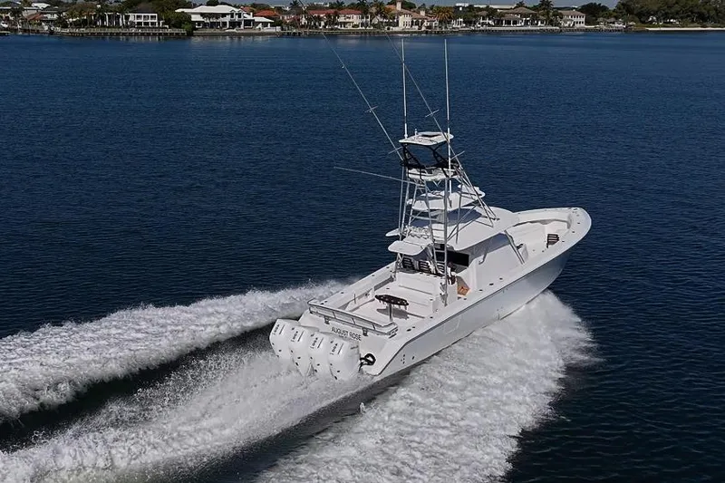 Slide: The Image of Sparks 46 boat cruising on water, 2025 model, with scenic coastal background. - 45