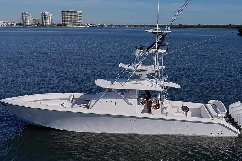 Slide: The Image of 2025 Sparks 46 boat on calm water with city skyline in background. - 5