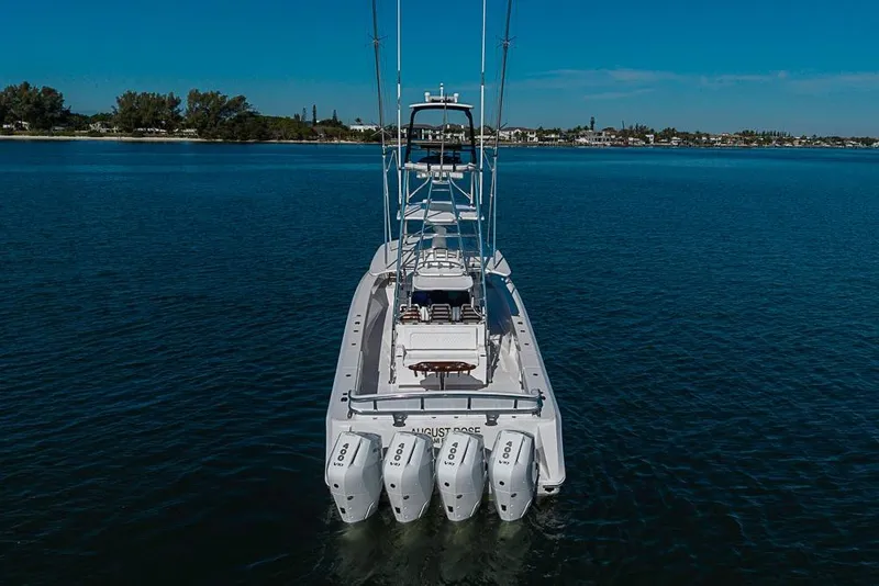 Slide: The Image of Aerial view of 2025 Sparks 46 boat with four powerful engines on calm water. - 56