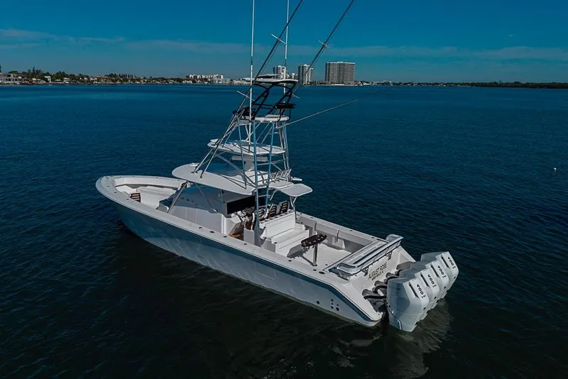 Slide: The Image of A 2025 Sparks 46 boat with multiple engines cruising on calm blue waters. - 57