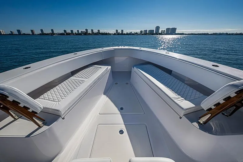 Slide: The Image of Luxurious 2025 Sparks 46 boat interior with cushioned seating, overlooking a city skyline on the water. - 60