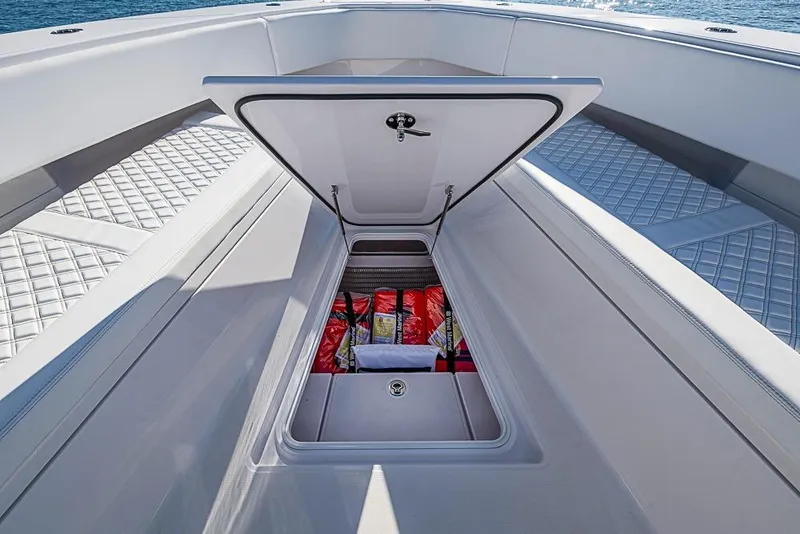 Slide: The Image of Open storage compartment on Sparks 46 boat, 2025 model, with safety equipment inside. - 61