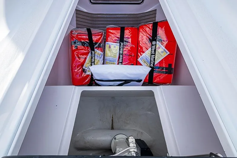 Slide: The Image of Storage compartment in a 2025 Sparks 46 boat with safety equipment. - 62