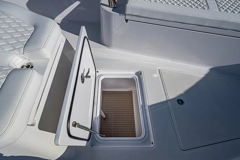 Slide: The Image of Open storage compartment on 2025 Sparks 46 boat with cushioned seating. - 65