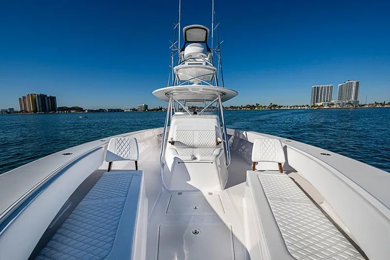 Slide: The Image of Luxurious 2025 Sparks 46 yacht on calm waters with city skyline backdrop. - 67