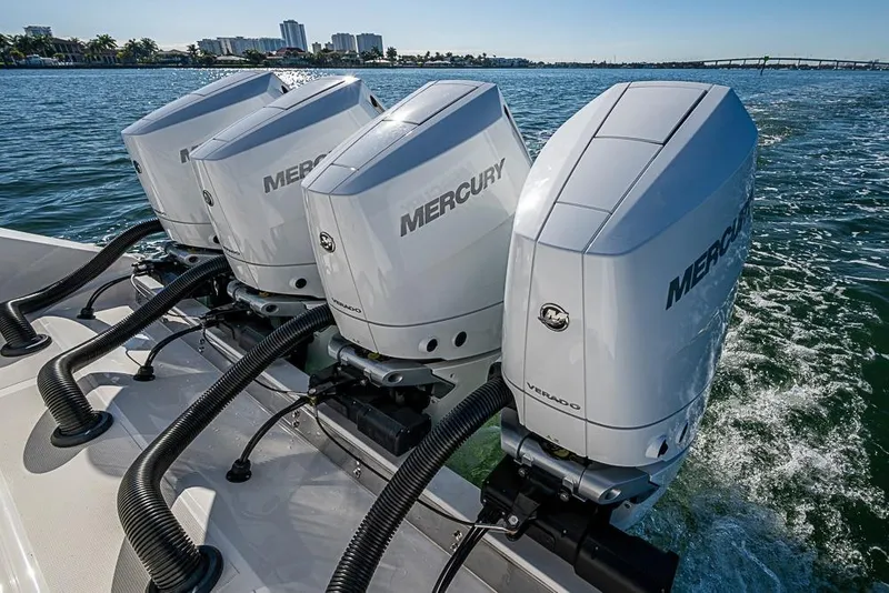 Slide: The Image of Four Mercury outboard engines on a Sparks 46 boat, 2025 model, cruising on water. - 96