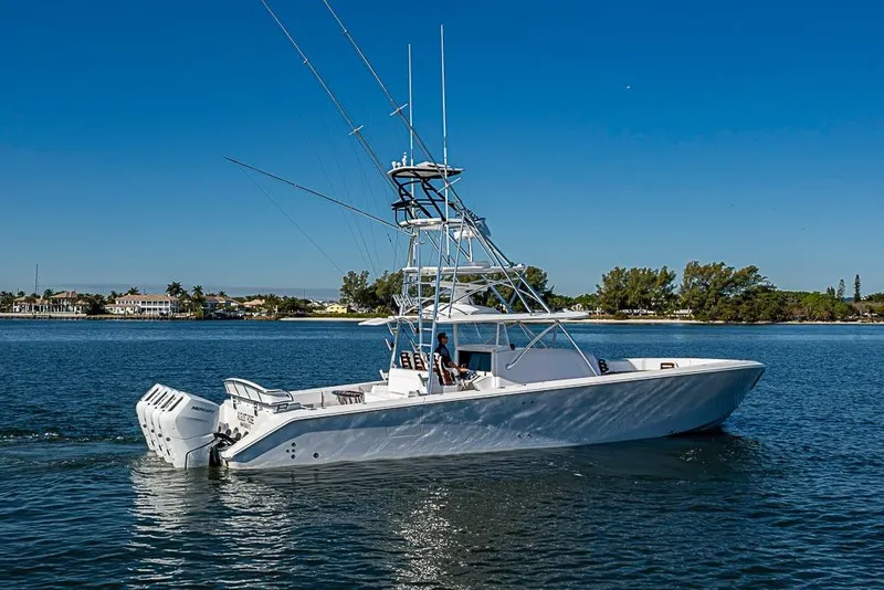 Slide: The Image of A sleek 2025 Sparks 46 boat cruising on a sunny day near a coastal area. - 98