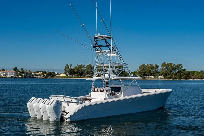 Slide: The Image of 2025 Sparks 46 boat with multiple engines cruising on a sunny day. - 99