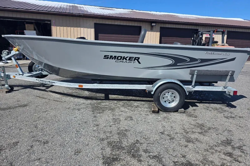 The Image of 2026 Smoker Craft Freedom 160 TL boat on trailer, parked outdoors. - 0