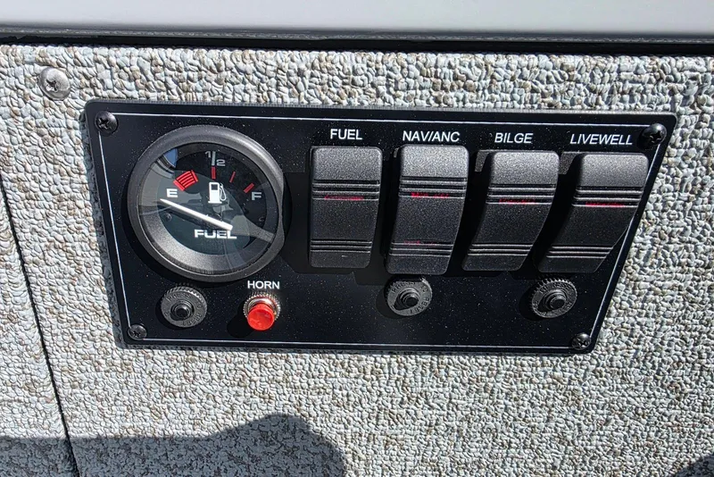 Slide: The Image of Control panel of 2026 Smoker Craft Freedom 160 TL boat with fuel gauge and switches. - 16