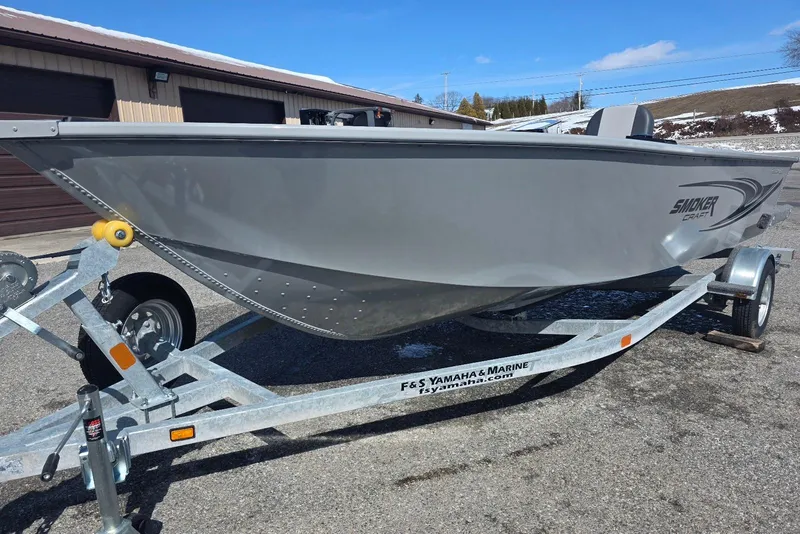 Slide: The Image of 2026 Smoker Craft Freedom 160 TL boat on trailer, parked outdoors. - 2