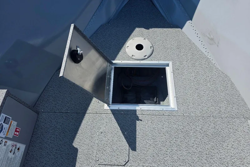 Slide: The Image of Open storage compartment on 2026 Smoker Craft Freedom 160 TL boat deck. - 9