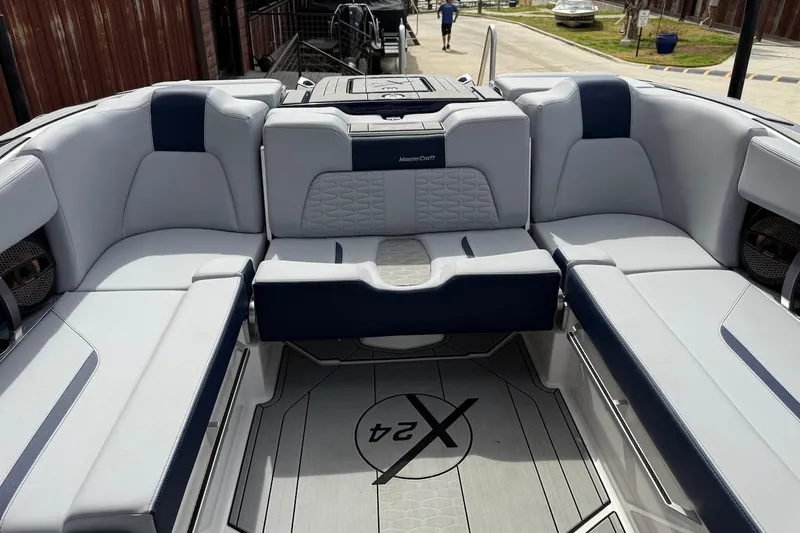 Slide: The Image of 2024 MasterCraft X24 boat interior with luxurious seating and modern design. - 16