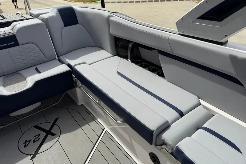 Slide: The Image of 2024 MasterCraft X24 boat interior with luxurious seating and modern design. - 17