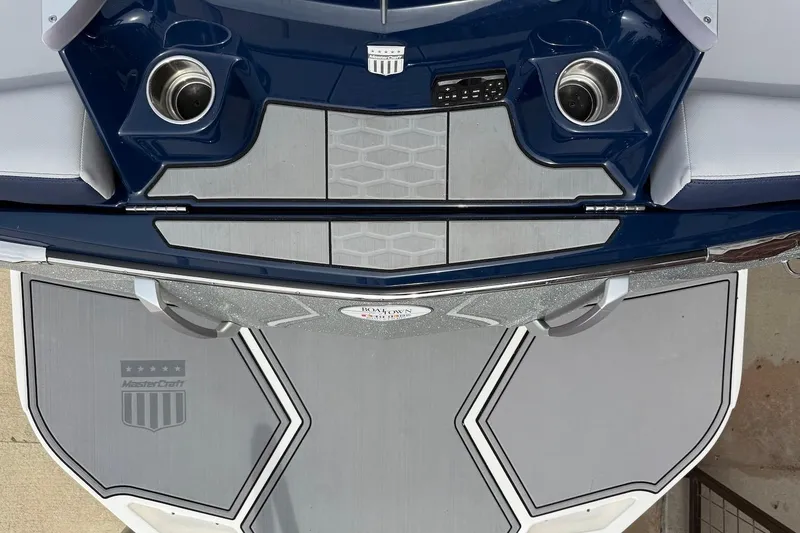 Slide: The Image of 2024 MasterCraft X24 boat interior with sleek design and cup holders. - 4
